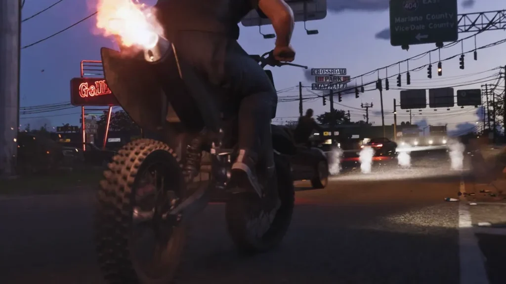 Motorcycle speeding through a busy intersection at night in GTA 6, with visible traffic, road signs, and flaming exhaust